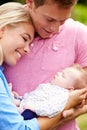 Proud Parents Holding Baby Daughter In Garden Royalty Free Stock Photo