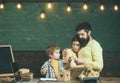 Proud parents watching sons success. Boy on busy face drawing or writing. Parent support concept. Parents watching their Royalty Free Stock Photo