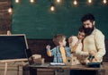 Proud parents watching sons success. Parent support concept. Parents watching their son drawing, learning to write Royalty Free Stock Photo