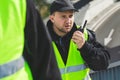 Policemen speaking on the walkie-talkie, reporting to station