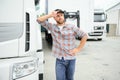 Proud Professional Trucker Standing in Front of His Truck. Trucking and Transportation Theme. Royalty Free Stock Photo