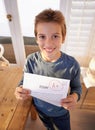 Proud of that A. a proud young boy holding up his essay that got him an A. Royalty Free Stock Photo