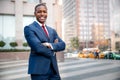 Proud successful businessman executive CEO african american, standing confidently with arms folded in downtown, financial building Royalty Free Stock Photo
