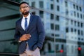 Proud successful businessman executive CEO african american, standing confidently with arms folded in downtown, financial building Royalty Free Stock Photo