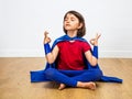 Proud superhero child practicing yoga and meditation for zen humour Royalty Free Stock Photo