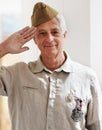 Proud veteran. A senior war veteran looking at the camera wearing his uniform. Royalty Free Stock Photo