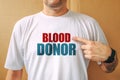 Proud volunteer blood donor wearing white t-shirt