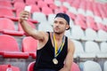 Proud winner with medals making selfie