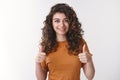 Proud you did great. Portrait happy impressed attractive supportive armenian girl wearing orange t-shirt show thumbs-up