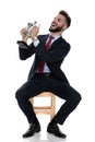 Proud young businessman smiling and presenting trophy Royalty Free Stock Photo