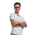 proud young man with glasses crossing arms, smiling and being confident Royalty Free Stock Photo