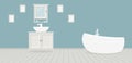 Provencal style bathroom with washbasin, a wardrobe, a fashionable bath and paintings on the blue wall. Light gray wooden planks