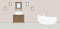Provencal style bathroom with washbasin, wardrobe, fashionable bath and paintings on a dusty rose wall. Light gray wooden planks