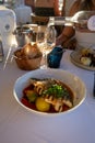 Provence cuisine, filet of seabass white fish served with potatoes, tomatoes and .Bouillabaisse jus in French restaurant