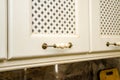 Provence style kitchen cabinet doors. Facade of beige kitchen cabinet figured door handles