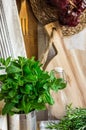 Provence style kitchen interior, white board wall, glass bottle, rattan coaster, linen towel, utensils Royalty Free Stock Photo