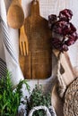 Provence style rustic kitchen interior, wood cutting boards, hanging linen towel, string with dry peppers