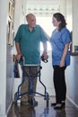 She provides the best senior care. a female nurse assisting her senior patient whos using a walker for support.
