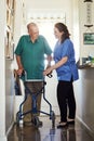 She provides the best senior care. Full length of a female nurse assisting her senior male patient with his walker.