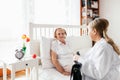 Providing care for elderly. Doctor visiting elderly patient at home. Royalty Free Stock Photo