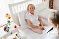 Providing care for elderly. Doctor visiting elderly patient at home. Royalty Free Stock Photo