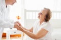 Providing care for elderly. Doctor visiting elderly patient at home. Royalty Free Stock Photo