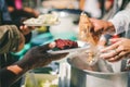 Providing free food to the poor Volunteers scooping out food to give charity to those who are hungry Royalty Free Stock Photo