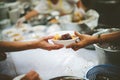 Providing free food to the poor Volunteers scooping out food to give charity to those who are hungry Royalty Free Stock Photo