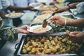 Providing free food to the poor Volunteers scooping out food to give charity to those who are hungry Royalty Free Stock Photo