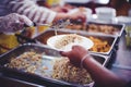 Providing free food to the poor Volunteers scooping out food to give charity to those who are hungry Royalty Free Stock Photo