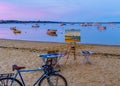 Provincetown, MA, USA - August 12 2017 Canvas, easel, bicycle, ships and boats in the Provincetown Marina during sunset