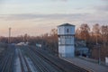 Provincial railway station, rails and water tower, spring evening Royalty Free Stock Photo