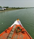 The prow of a bright red Fishing and tourist boat sailing in the Bay of Bengal- Sundarban, India- 9th Feb 2018