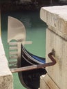 Prow of a gondola in a canal between the streets of Venice Royalty Free Stock Photo