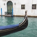 Prow of gondola floats on quiet canal, Venice, Italy