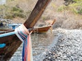 Prow of local traditional long tail boat tied with fabric three colors