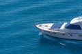 Prow of a yacht with sun loungers at the stern floating on the water surface in summer Royalty Free Stock Photo