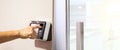 Proximity card door unlock, Hand security man using fingerprint scan on ID card reader access control system for identity