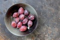 Prune plums in a gray bowl