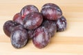 Prune plums on wooden table Royalty Free Stock Photo