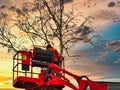 Pruner on cherry picker cutting tree in the air Royalty Free Stock Photo