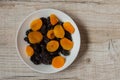 Prunes and dried apricots in a bowl on a light wooden background Royalty Free Stock Photo