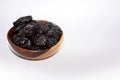 Prunes isolated on white background, dried plums collection in a brown wooden bowl isolated Royalty Free Stock Photo