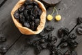 prunes and yellow cherries on a dark background