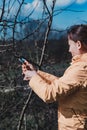 Pruning tree branches in the garden in spring, A woman cuts unnecessary branches from a fruit tree. Royalty Free Stock Photo