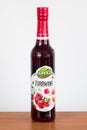 Lowicz cranberry juice in a glass bottle on wooden table