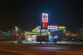 Lotos gas station at night. Lotos gas station with higher price for diesel then 95 octane fuel on price board