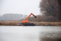 Pryluky, Chernihiv / Ukraine - 11/19/2020: Amphibious Excavators. River Cleaning