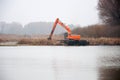 Pryluky, Chernihiv / Ukraine - 11/19/2020: Amphibious Excavators. River Cleaning