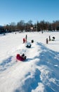 Pryluky, Chernihiv, Ukraine - 02/15/2021: Children ride with their parents on a snow slide in the city square